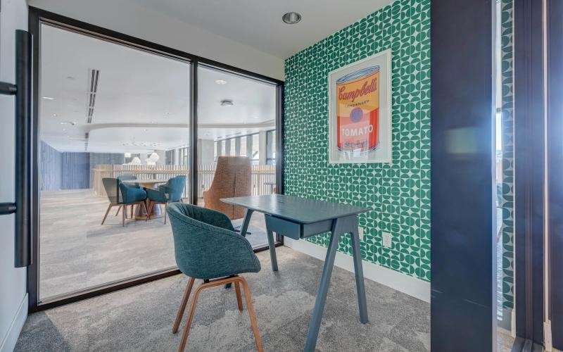 a private room with a desk and a chair