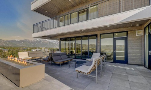 a patio with couches and a fireplace