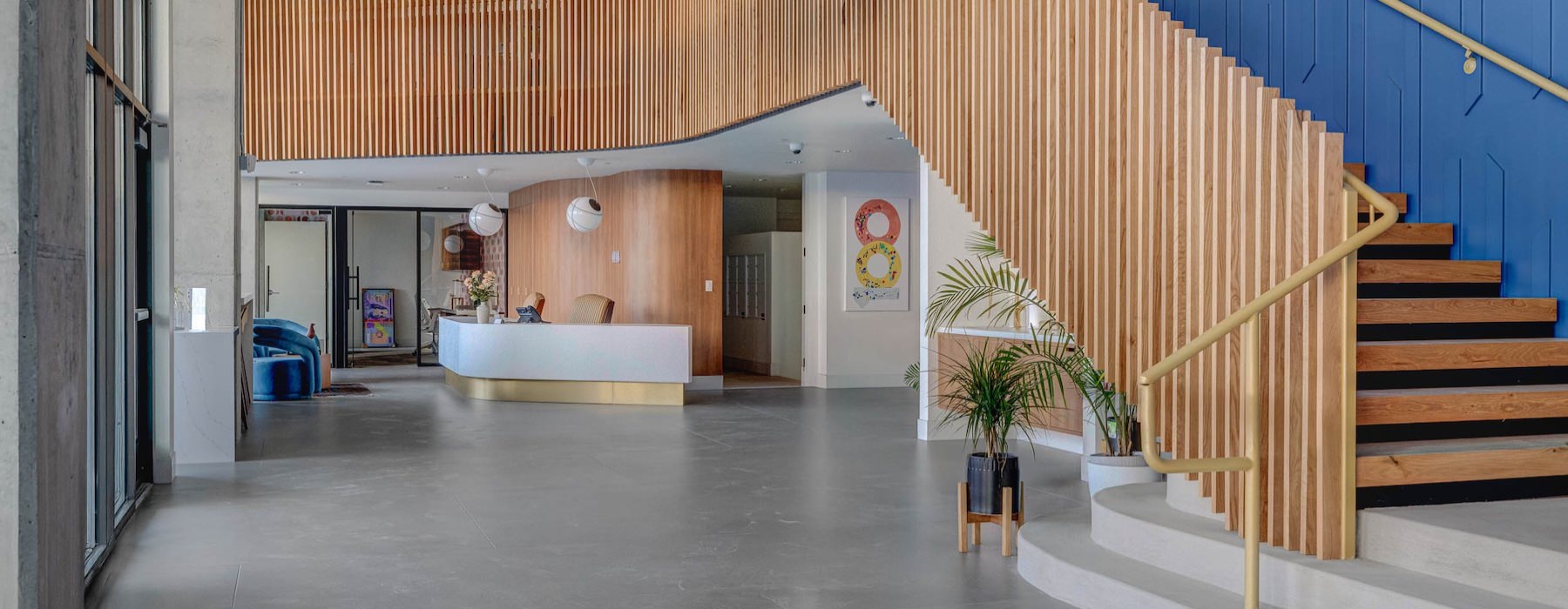 a lobby with stairs and a front desk