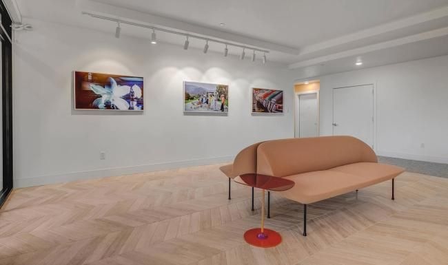 an art gallery with couches