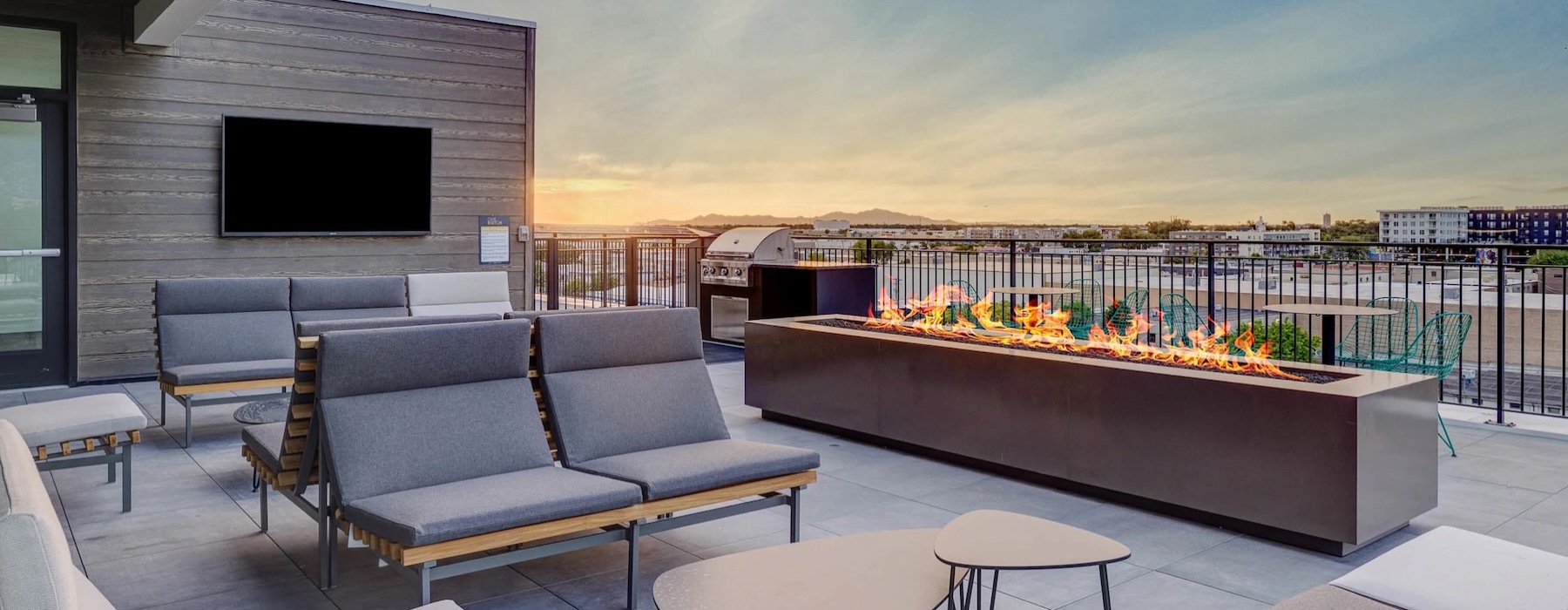 a patio with chairs and a fireplace