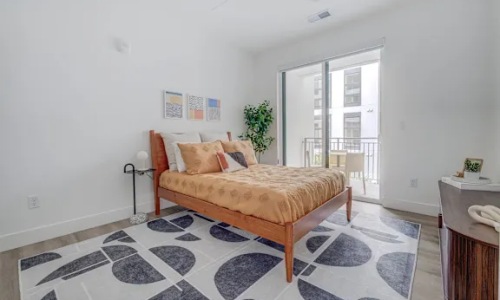a bedroom with a bed and a dresser